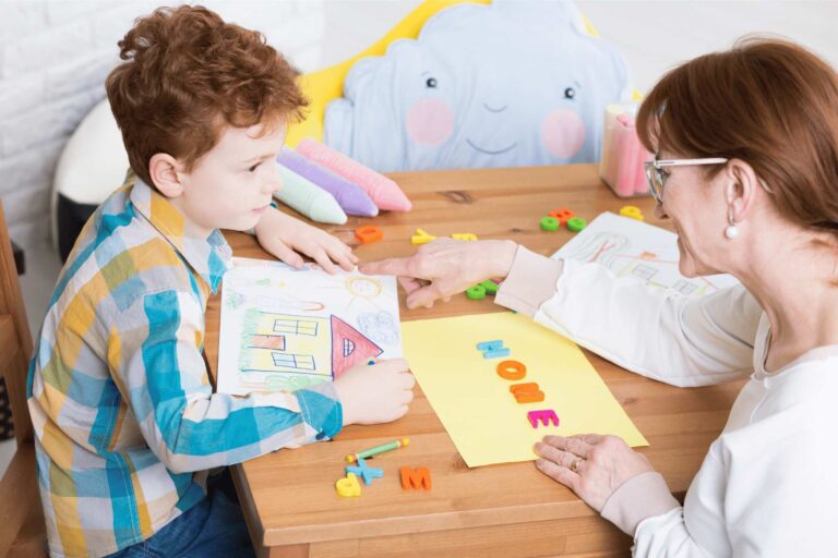 ABA therapy professional working with a child to encourage good student behavior through consistent and structured activities