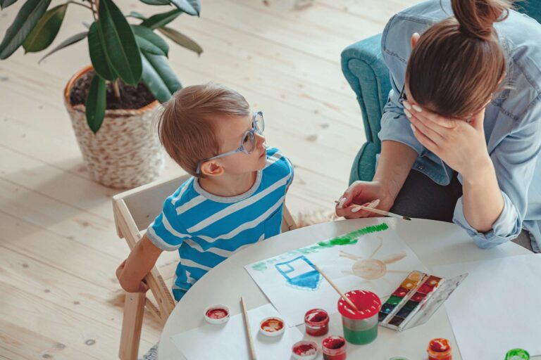 A mother and son practicing stress management techniques at home