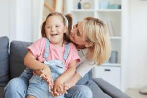 Early diagnosis of autism: A smiling mother with her autistic daughter