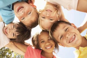 Smiling children hugging, strengthening autism and friendship